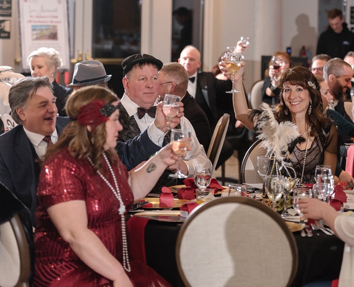 Photo of table full of guests dressed in 1920's garb